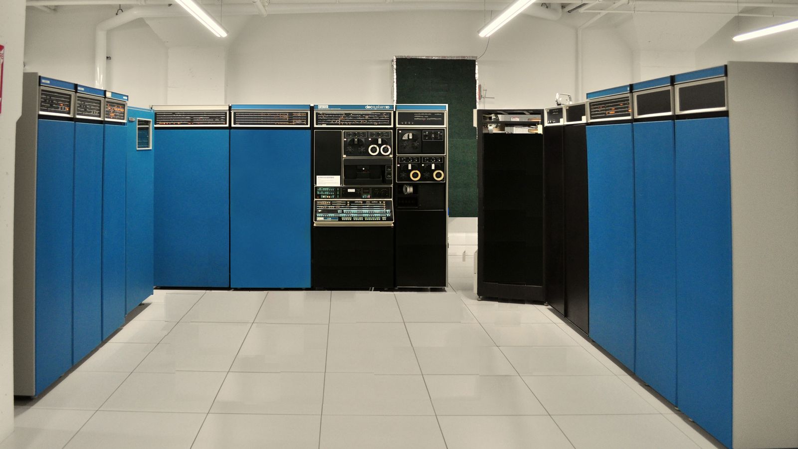 A row of blue mainframe computer cabinets in a computer room