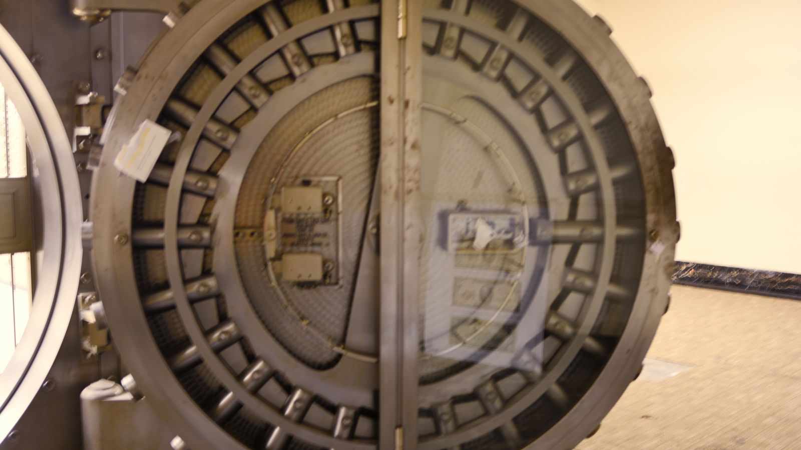 A massive round bank vault door seen from the front