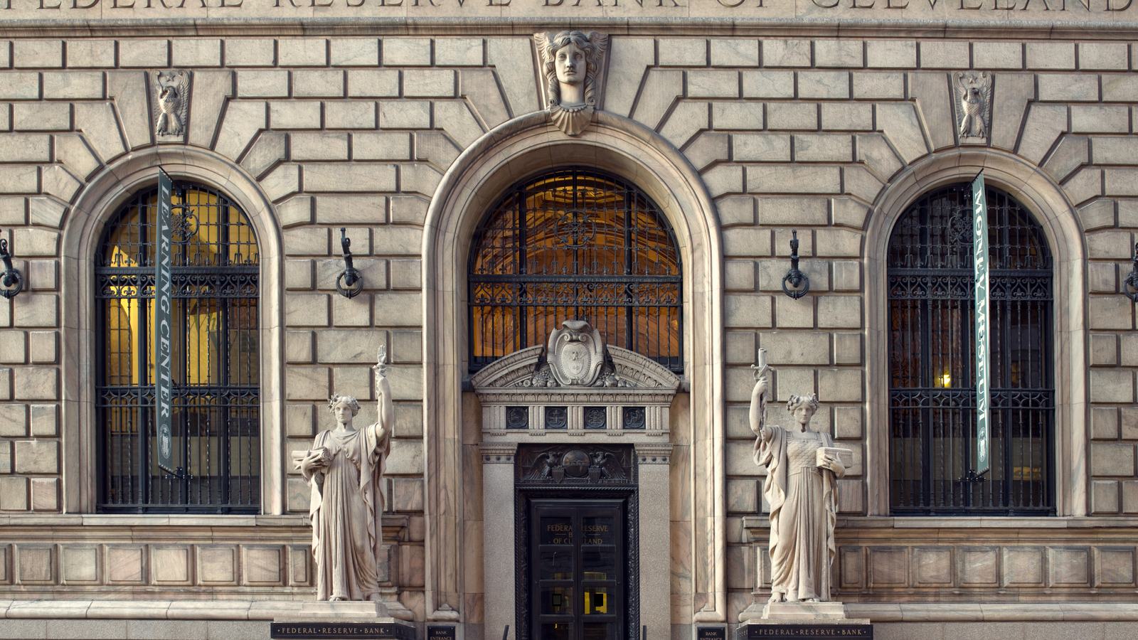 The carved stone entrance of the Federal Reserve Bank of Cleveland, with its name above the arched windows