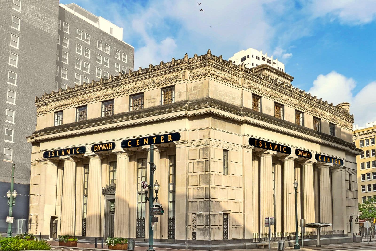 A classical stone bank building on a city street corner