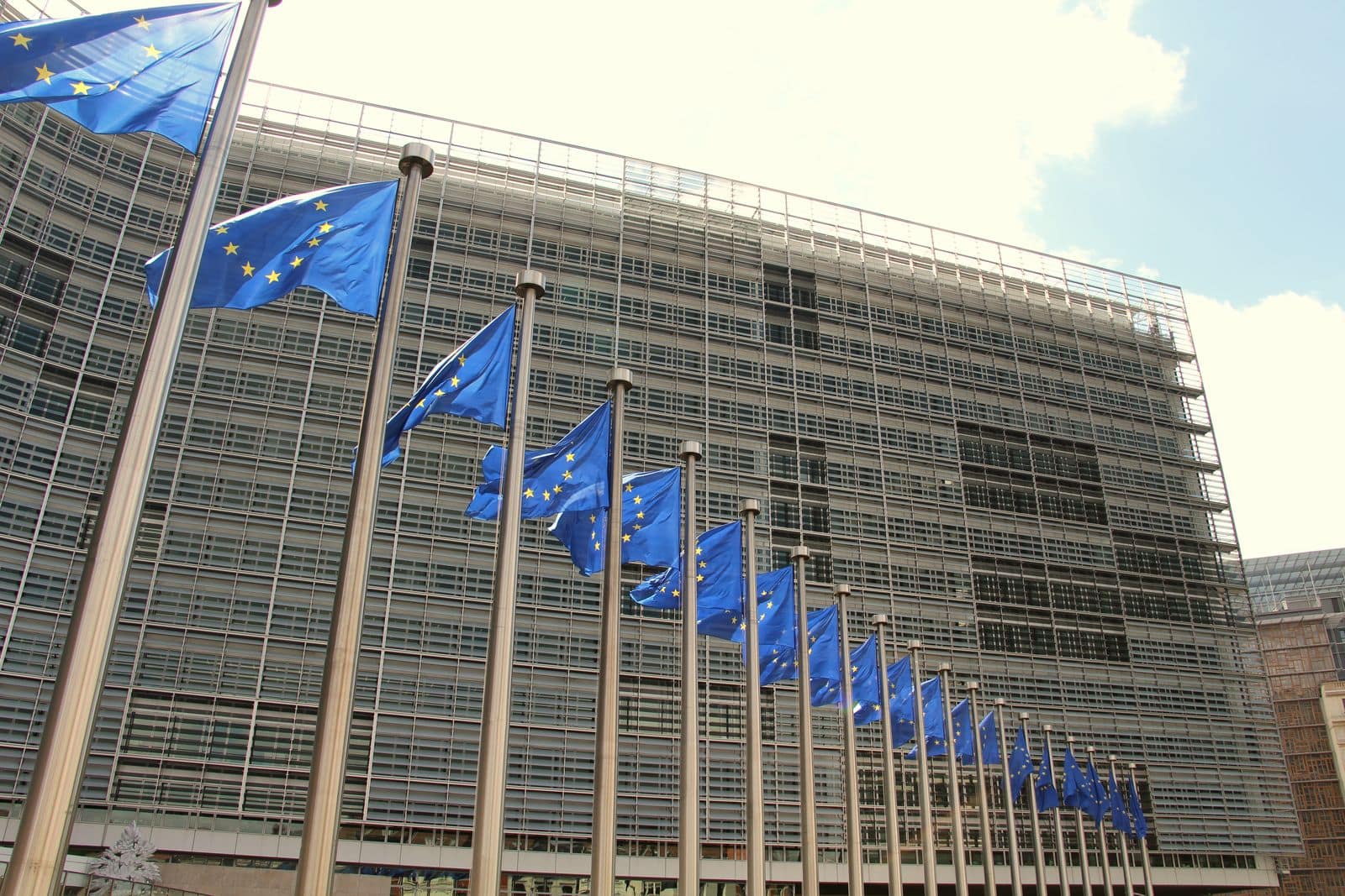 A row of EU flags outside the European Commission building