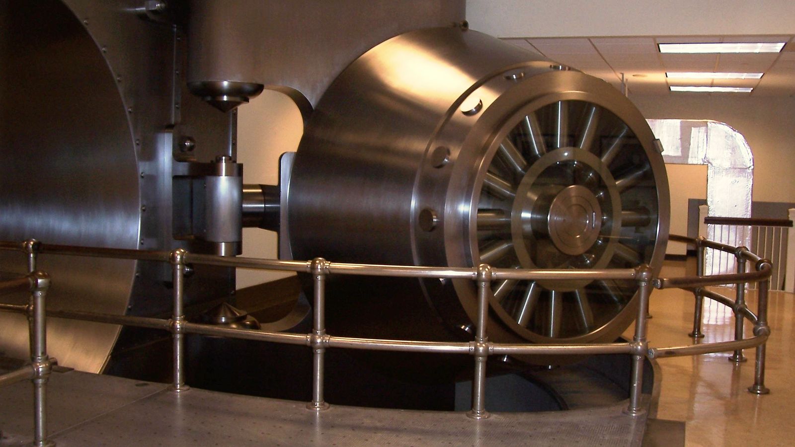 A huge round vault door on its hinge in a bank basement