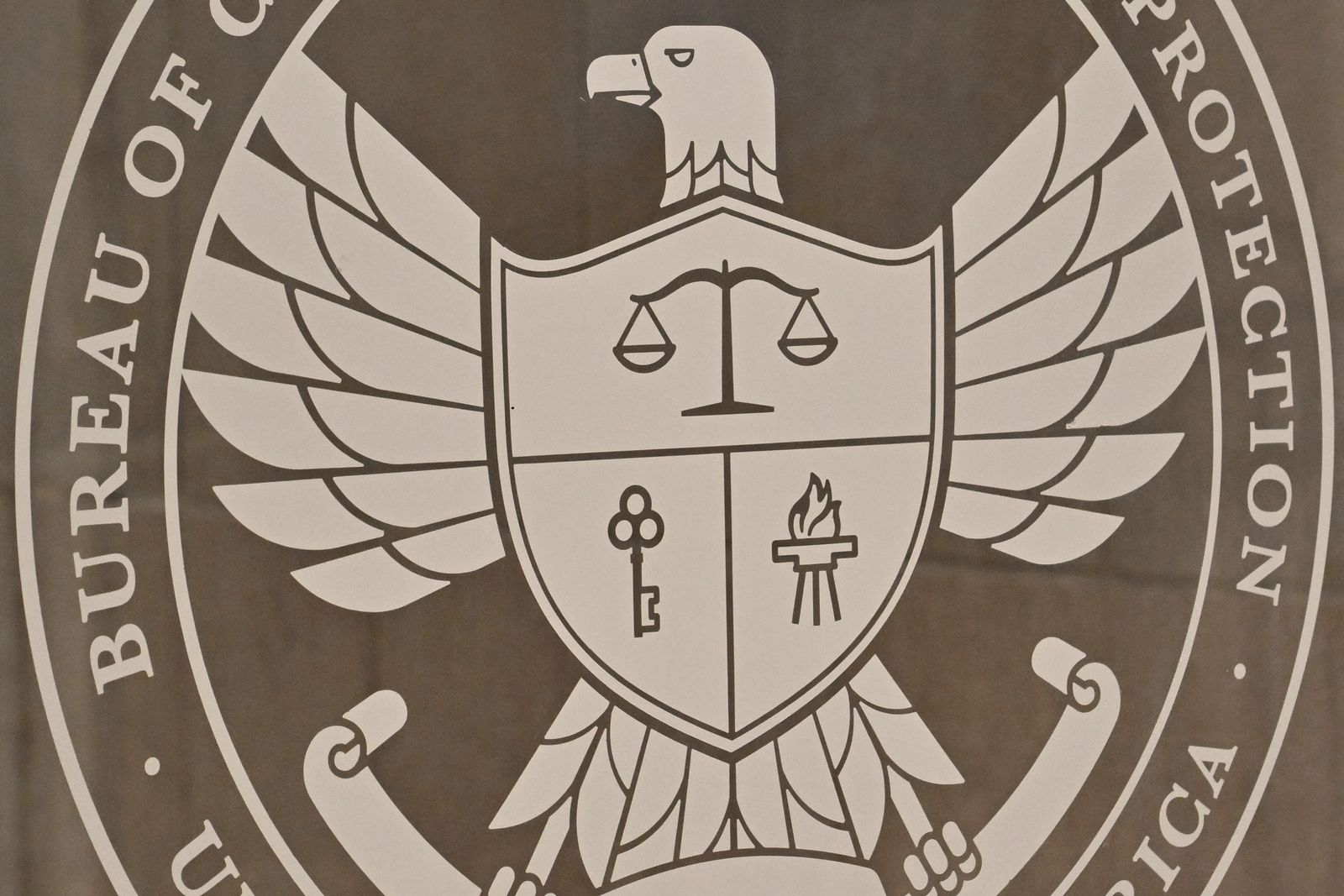 The seal of the Consumer Financial Protection Bureau on a wall