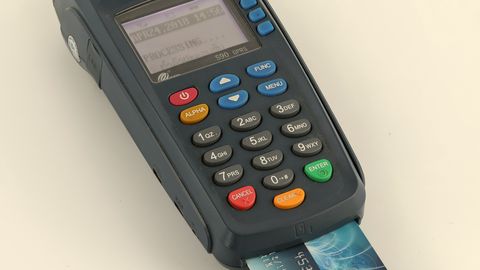 A card payment terminal with a bank card inserted into its chip reader