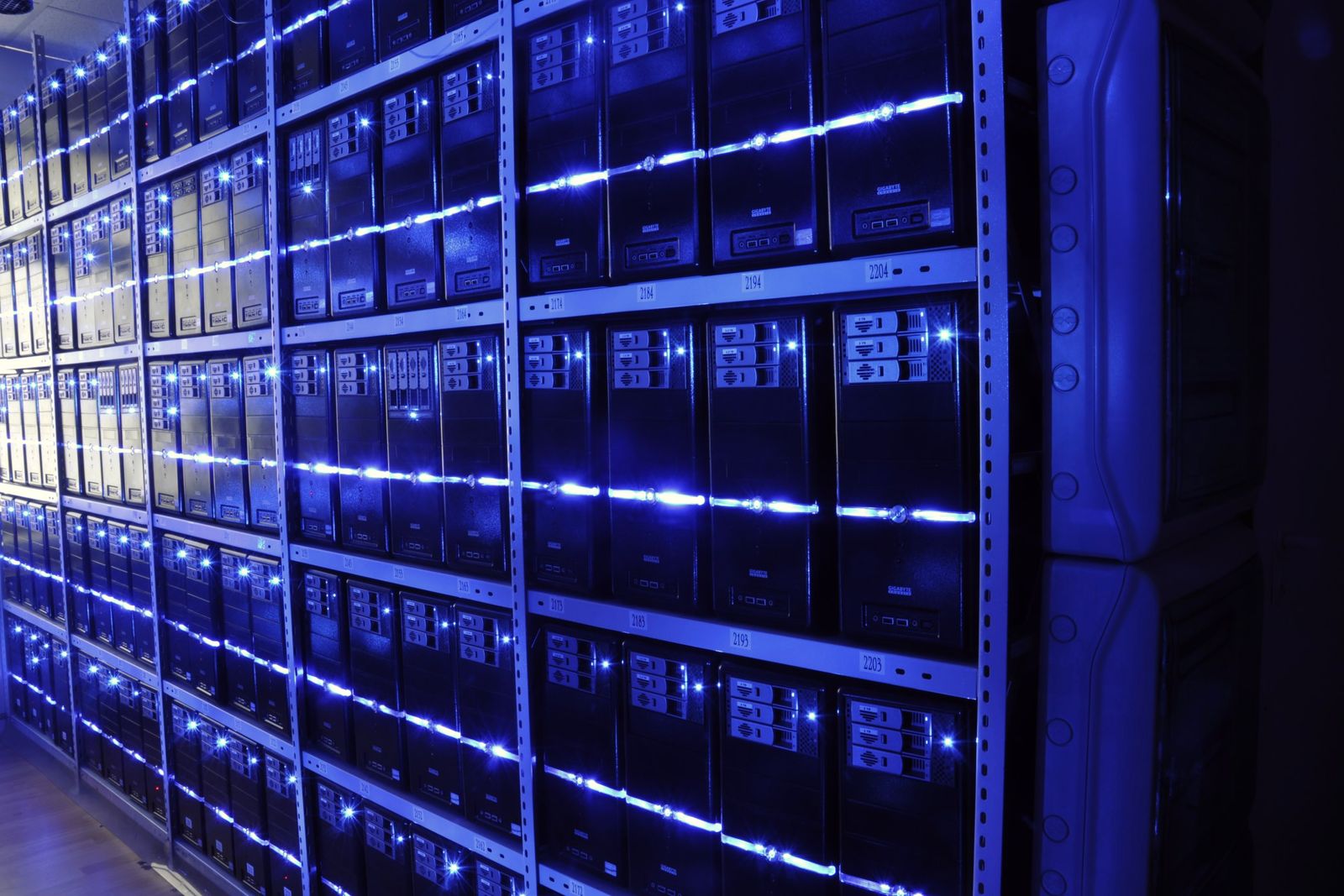 Rows of server racks lit in blue