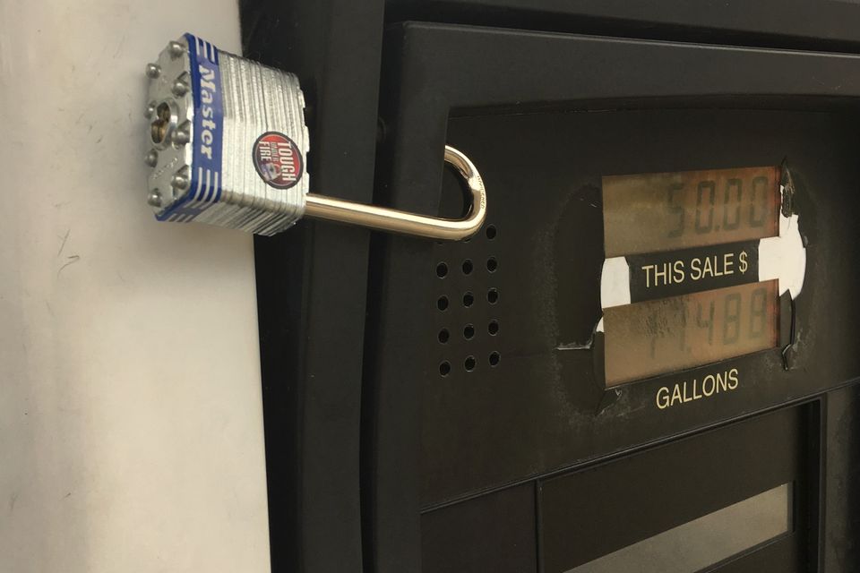 A padlock on a fuel pump panel to stop thieves fitting card skimmers