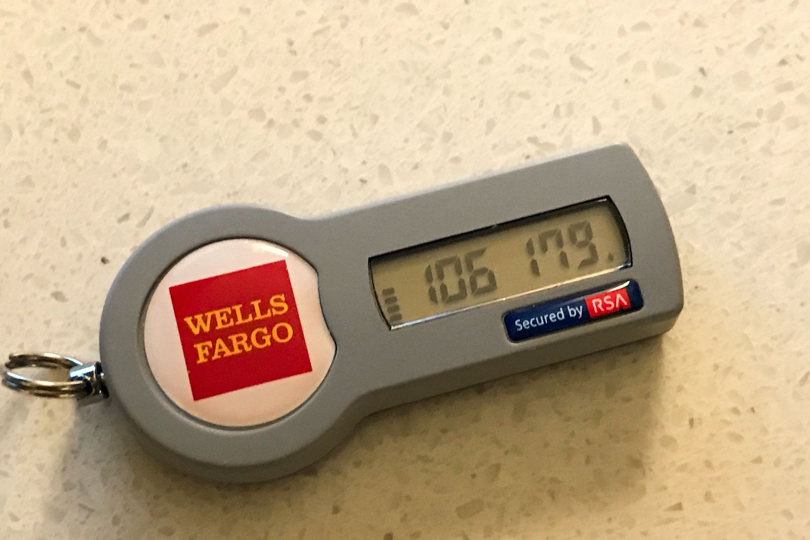A bank-issued key-fob token showing a one-time passcode