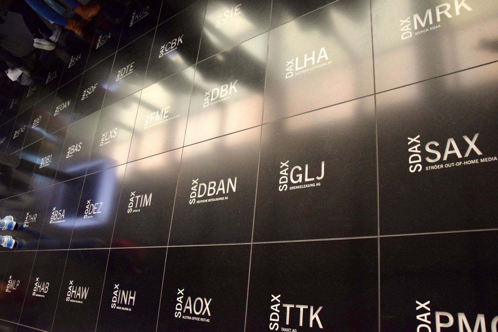 Share ticker symbols projected on a dark wall