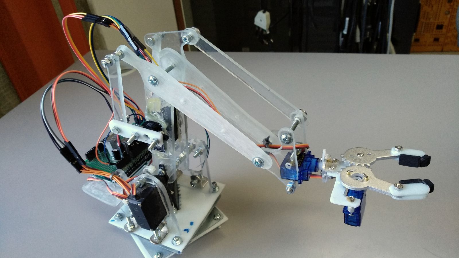 A small home-built robotic arm on a workbench